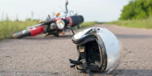crashed motorcycle with helmet on roadway