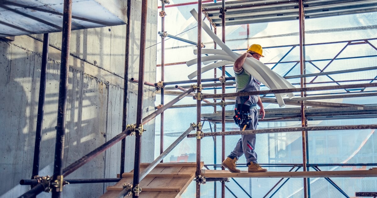 stock image of construction worker on scaffolding