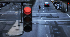 stock image of a busy city street with a big red light in the foreground