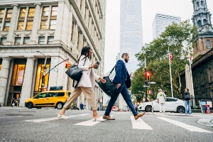 Pedestrians crossing the street in a city.