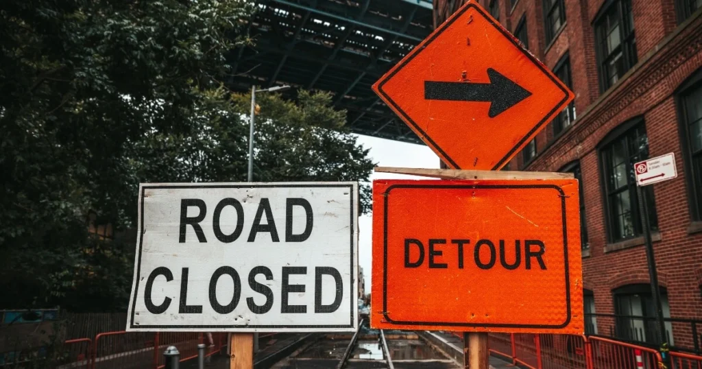 Road signs alerting for detours and road closure.