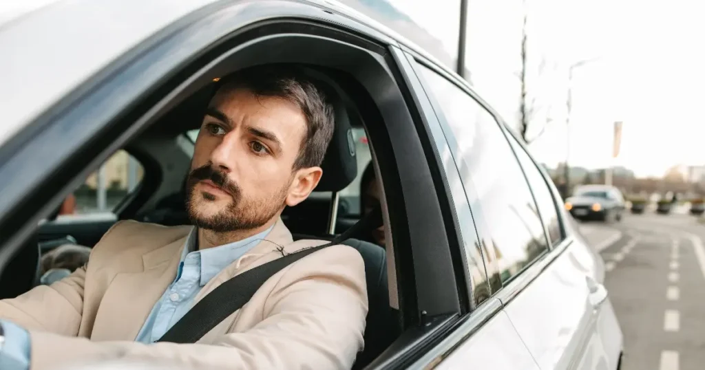 young professional male driving in city