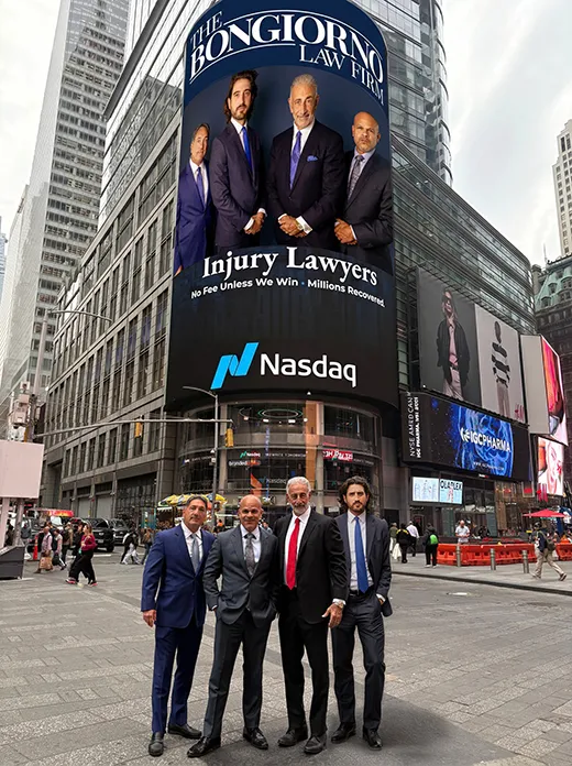 Bongiorno team posing in front their Nasdaq billboard in Time Square