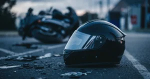 helmet on road beside crashed motorcycle